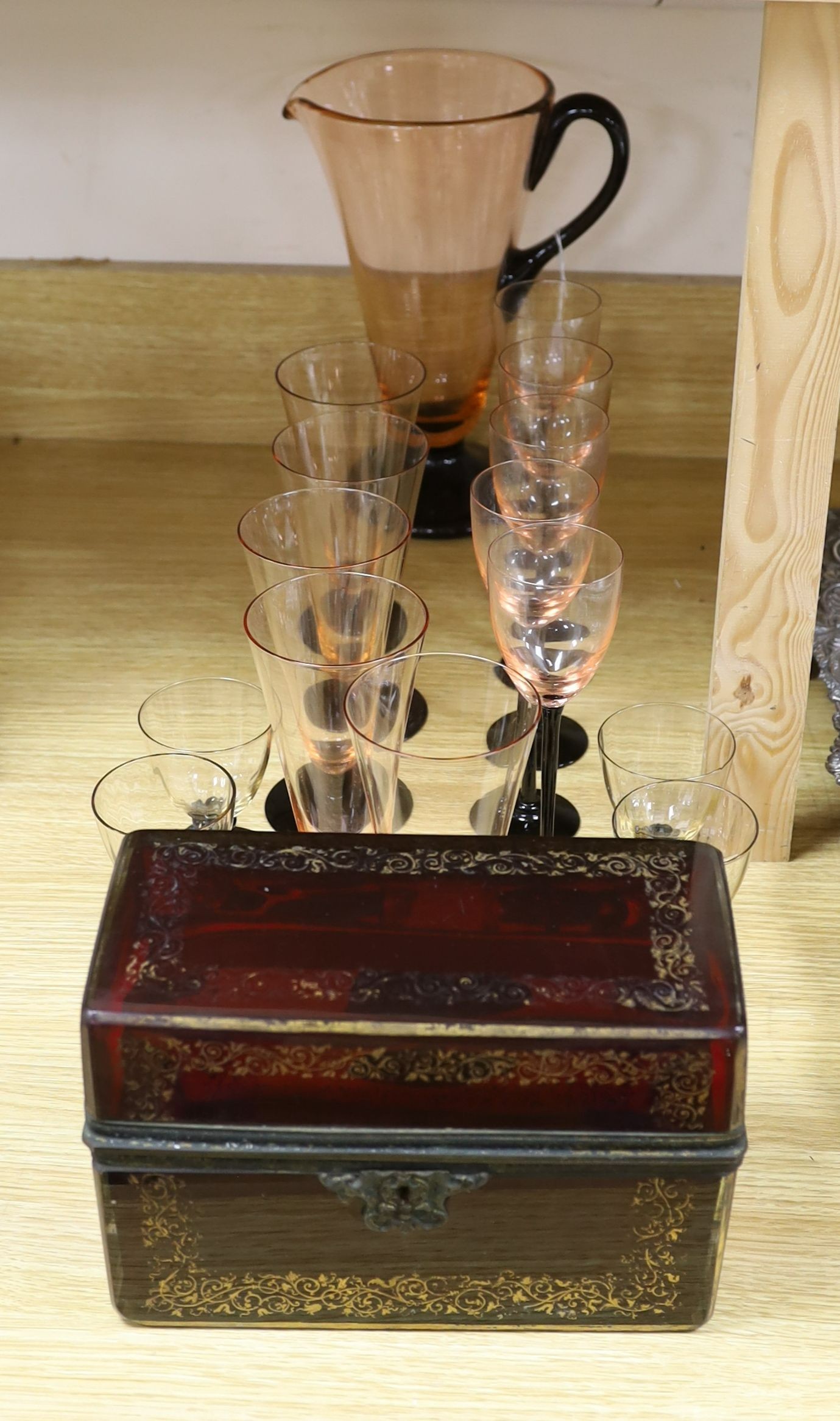 A Bohemian ruby glass casket and an Art Deco style part lemonade set in black and pink glass (14 glasses and a jug)